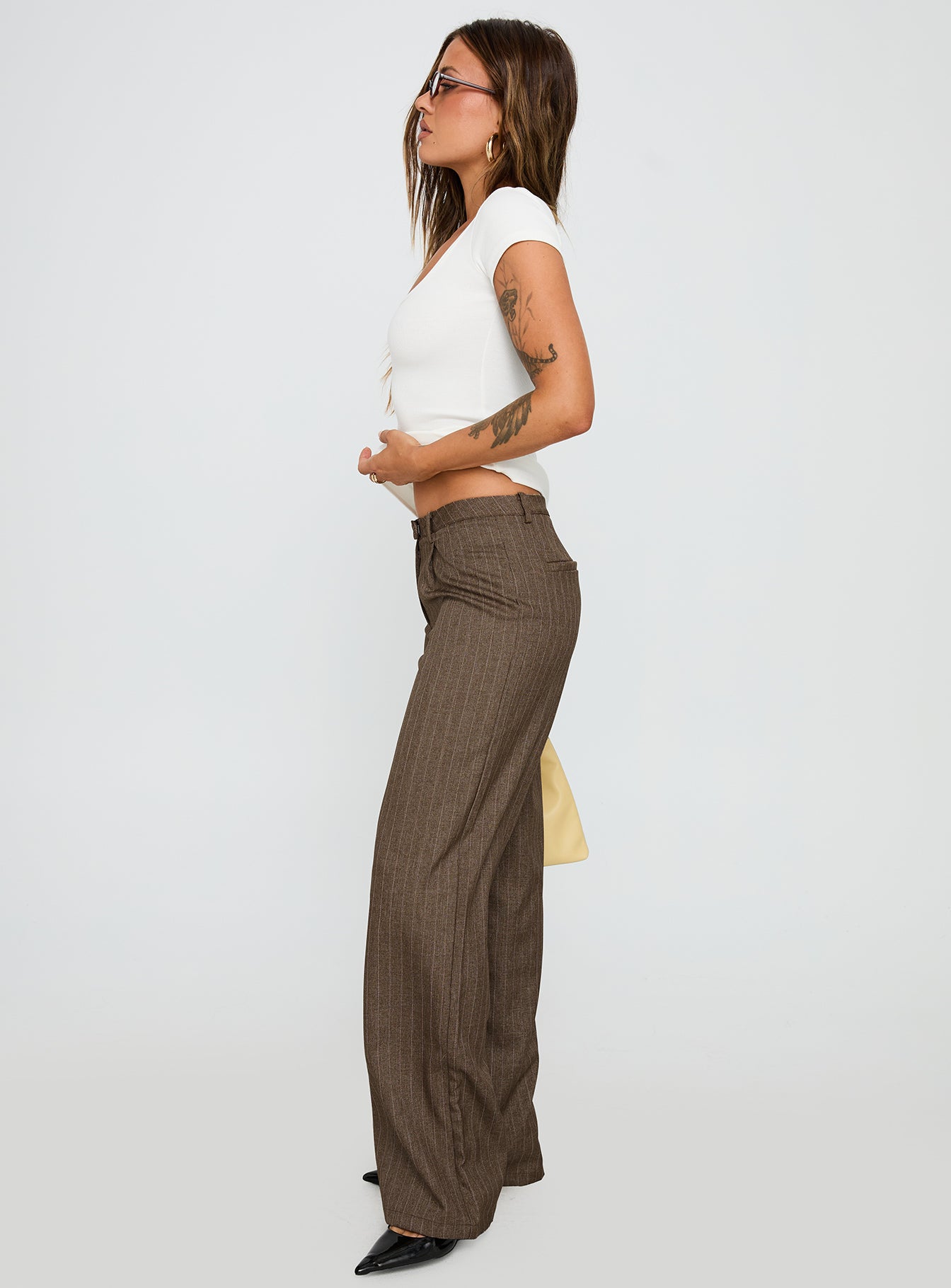 side view of model wearing Princess Polly Broadcast Pants Beige Pinstripe Low Rise Pants 