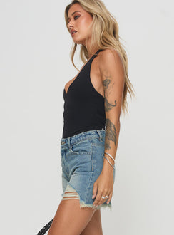 side view of model wearing Princess Polly Tranquility Shorts Light Wash High Waisted Shorts 