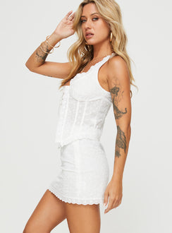 Two piece broderie anglaise set Crop top, Fixed shoulder straps, v-neckline, tie fastening at bust, split hem High rise mini skirt, invisible zip fastening at side