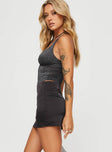   side view of model wearing Princess Polly Karley Satin Low Waist Mini Skirt Black Petite Mini Skirts 