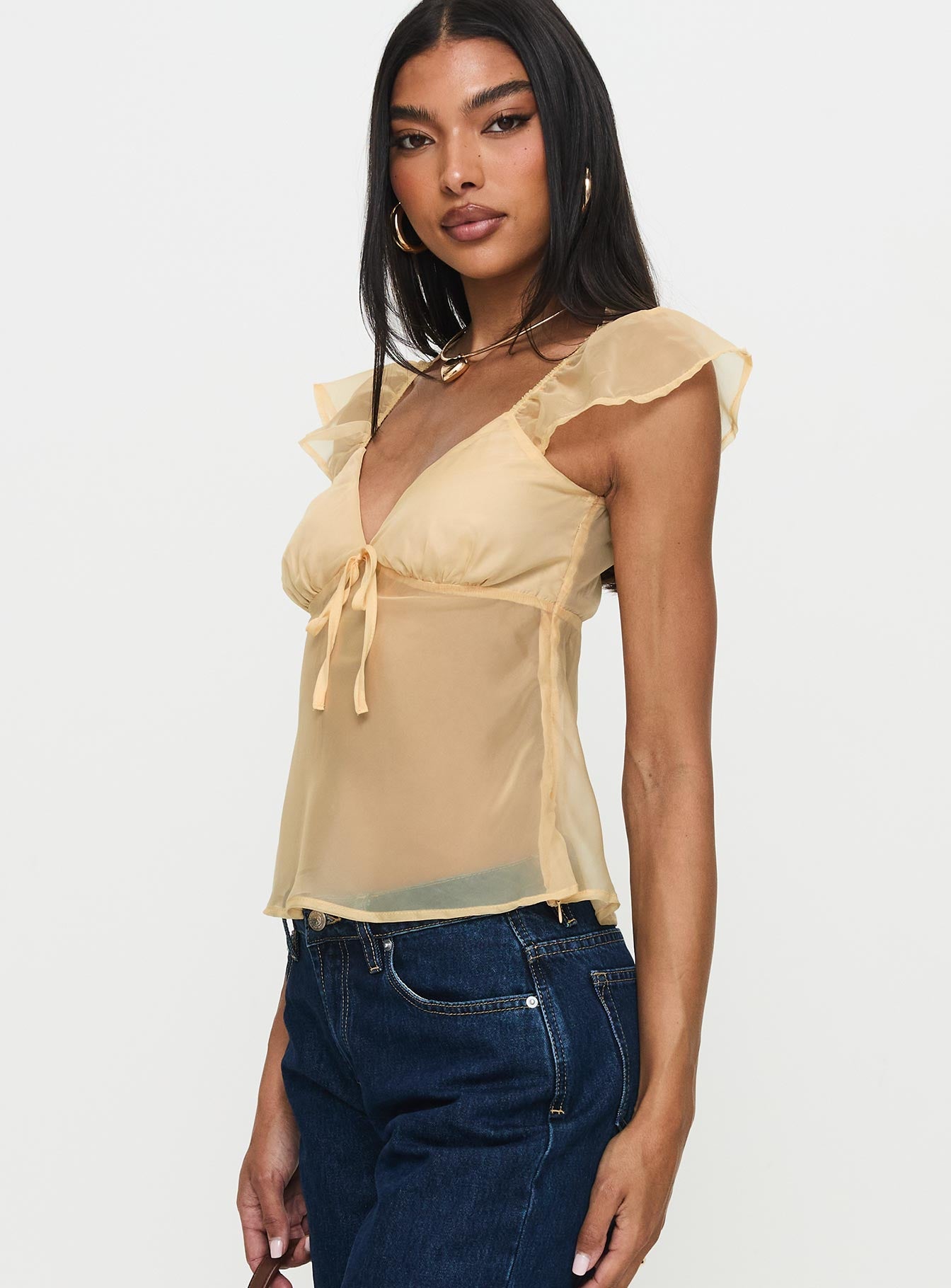 side view of model wearing Princess Polly Keysia Cap Sleeve Sheer Top Apricot Short Sleeves Plunger 