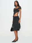   side view of model wearing Princess Polly Legacy Midi Skirt Onyx Polka 