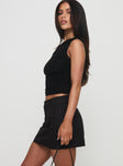   side view of model wearing Princess Polly Ember Low Waist Mini Skirt Black Pinstripe Mini Skirts 