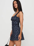 side view of model wearing Princess Polly Dasha Mini Dress Navy Floral Square Neck 