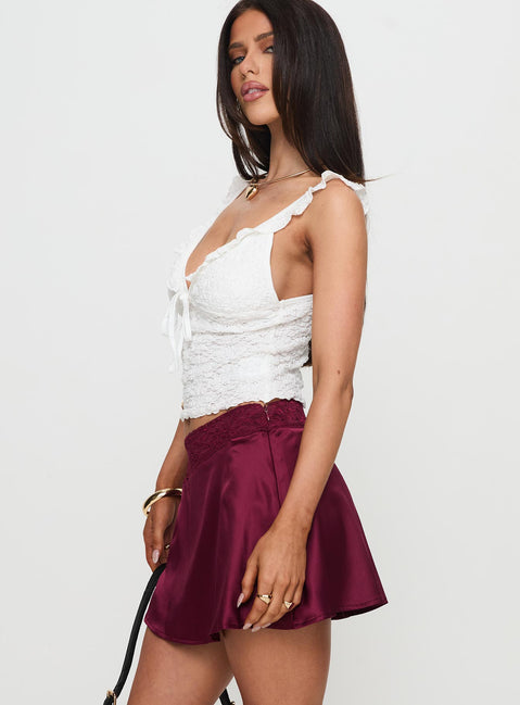   side view of model wearing Princess Polly For Me Mini Skirt Burgundy Mini Skirts 