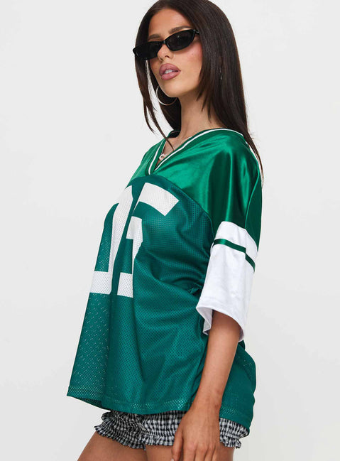 side view of model wearing Princess Polly Kronwall Sports Jersey Top Green / White Three Fourth Sleeves V-Neck 