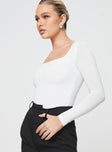 side view of model wearing Princess Polly Crasey Long Sleeve Bodysuit White Full Sleeves Square Neck 