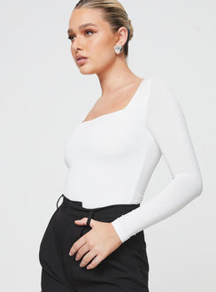 side view of model wearing Princess Polly Crasey Long Sleeve Bodysuit White Full Sleeves Square Neck 