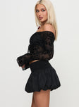 side view of model wearing Princess Polly French Exit Bubble Hem Skort Black High Waisted Shorts 