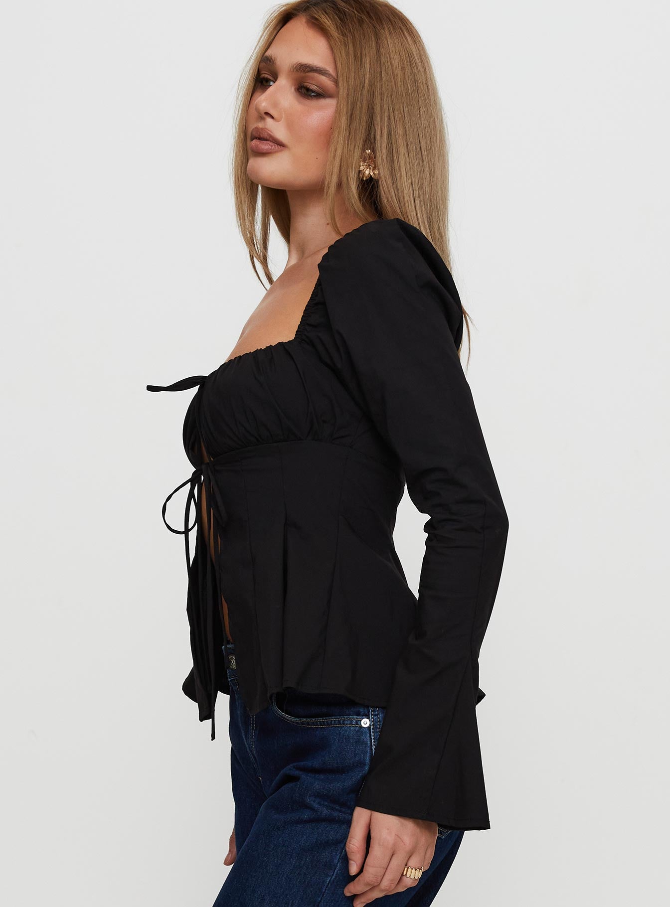 side view of model wearing Princess Polly Lilibette Tie Up Long Sleeve Top Black Full Sleeves Square Neck 