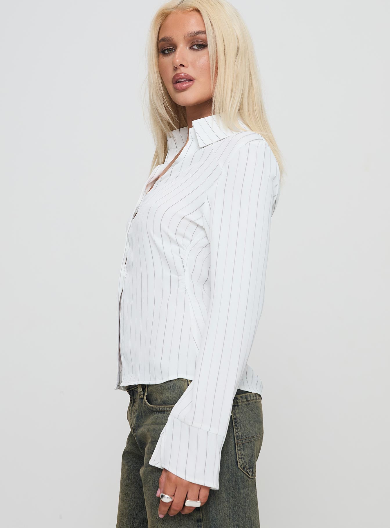 side view of model wearing Princess Polly Aldgate Long Sleeve Top White Full Sleeves V-Neck 