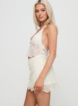   side view of model wearing Princess Polly Lumache Lace Mini Skirt Cream Mini Skirts 