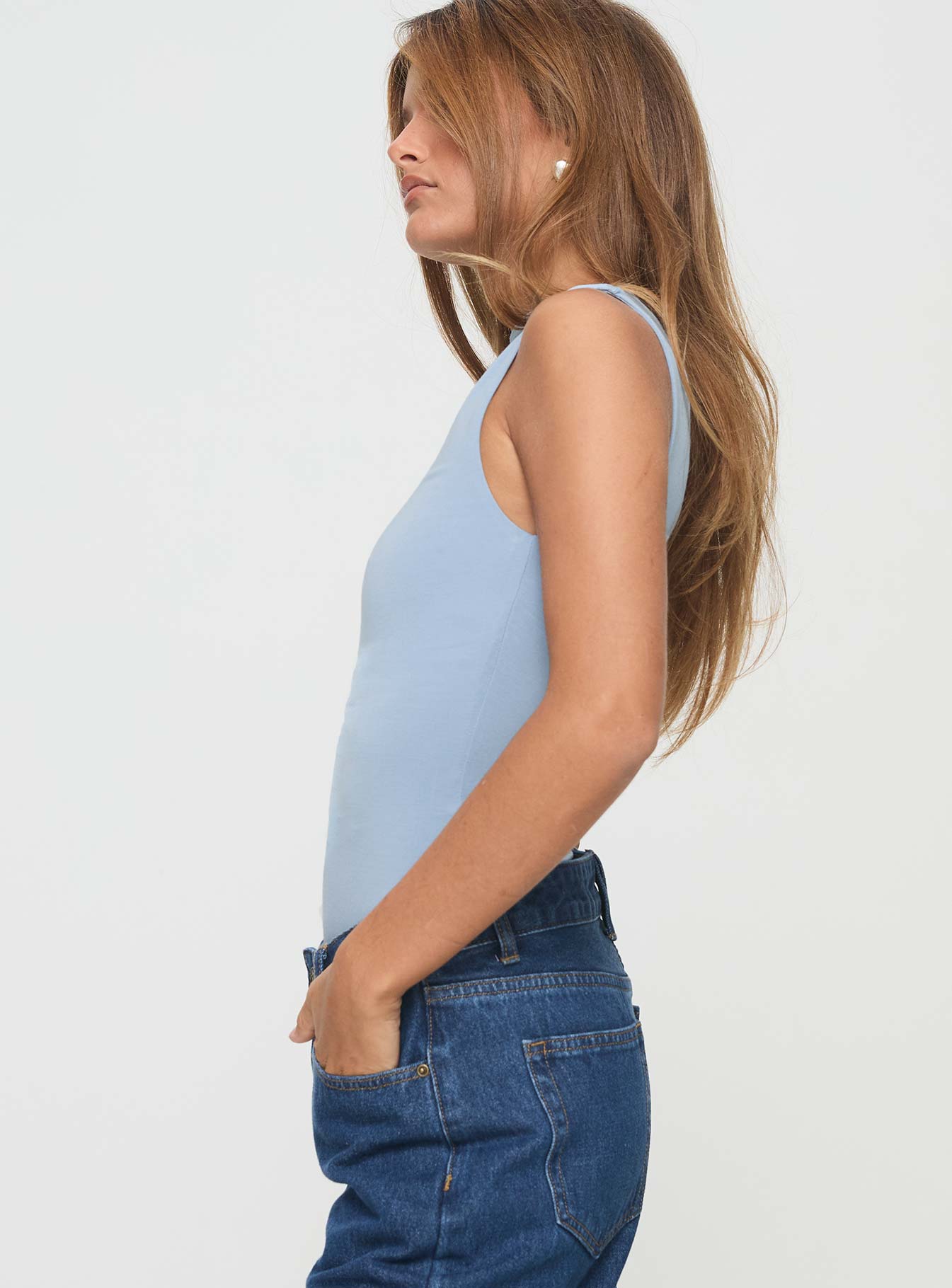 side view of model wearing Princess Polly Josefine Bodysuit Baby Blue Sleeveless High Neck 
