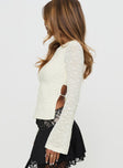 side view of model wearing Princess Polly Shellee Long Sleeve Tie Back Top Cream Full Sleeves Crew Neck 