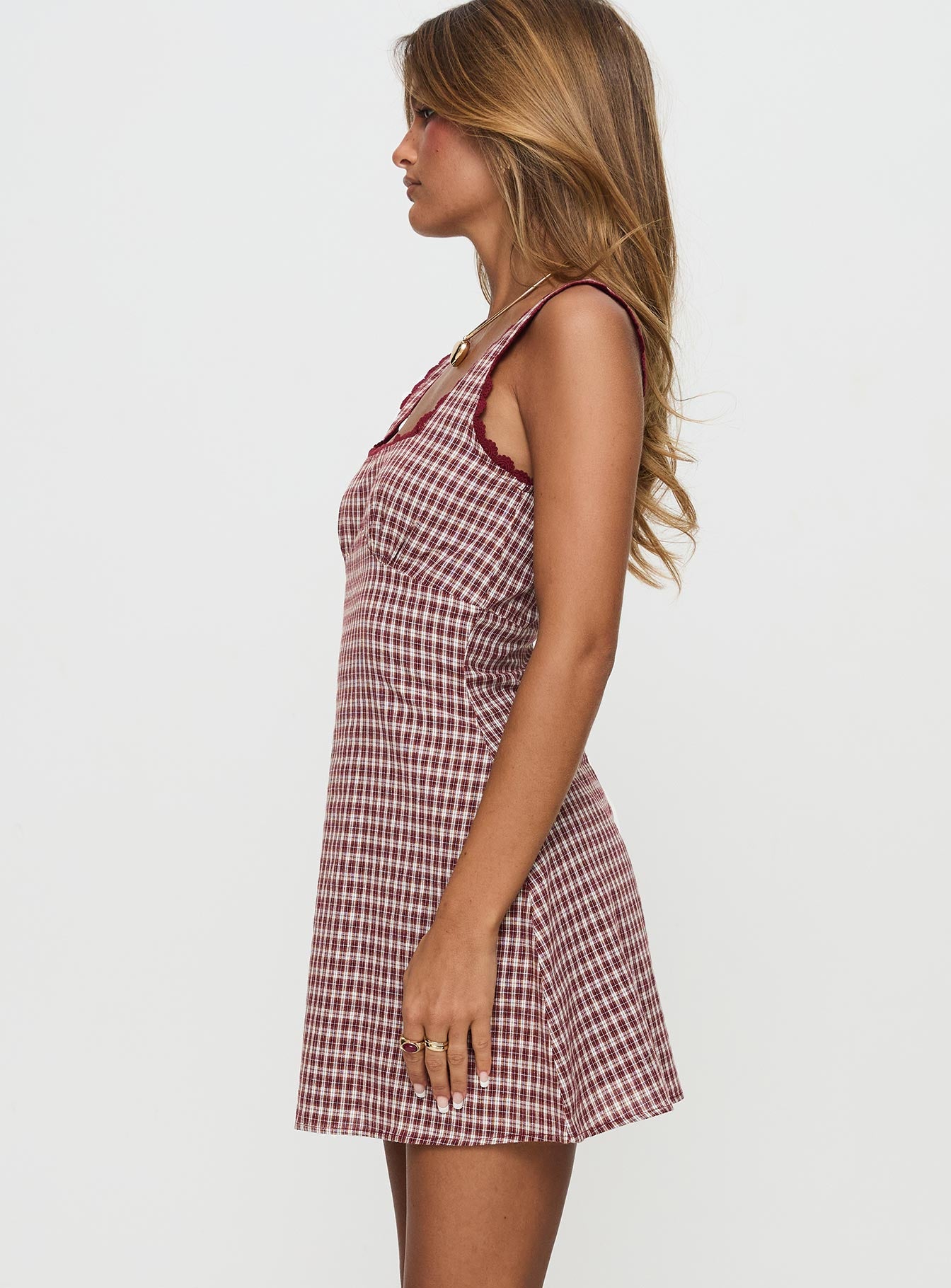 side view of model wearing Princess Polly Dasha Mini Dress Red Check Petite Square Neck 