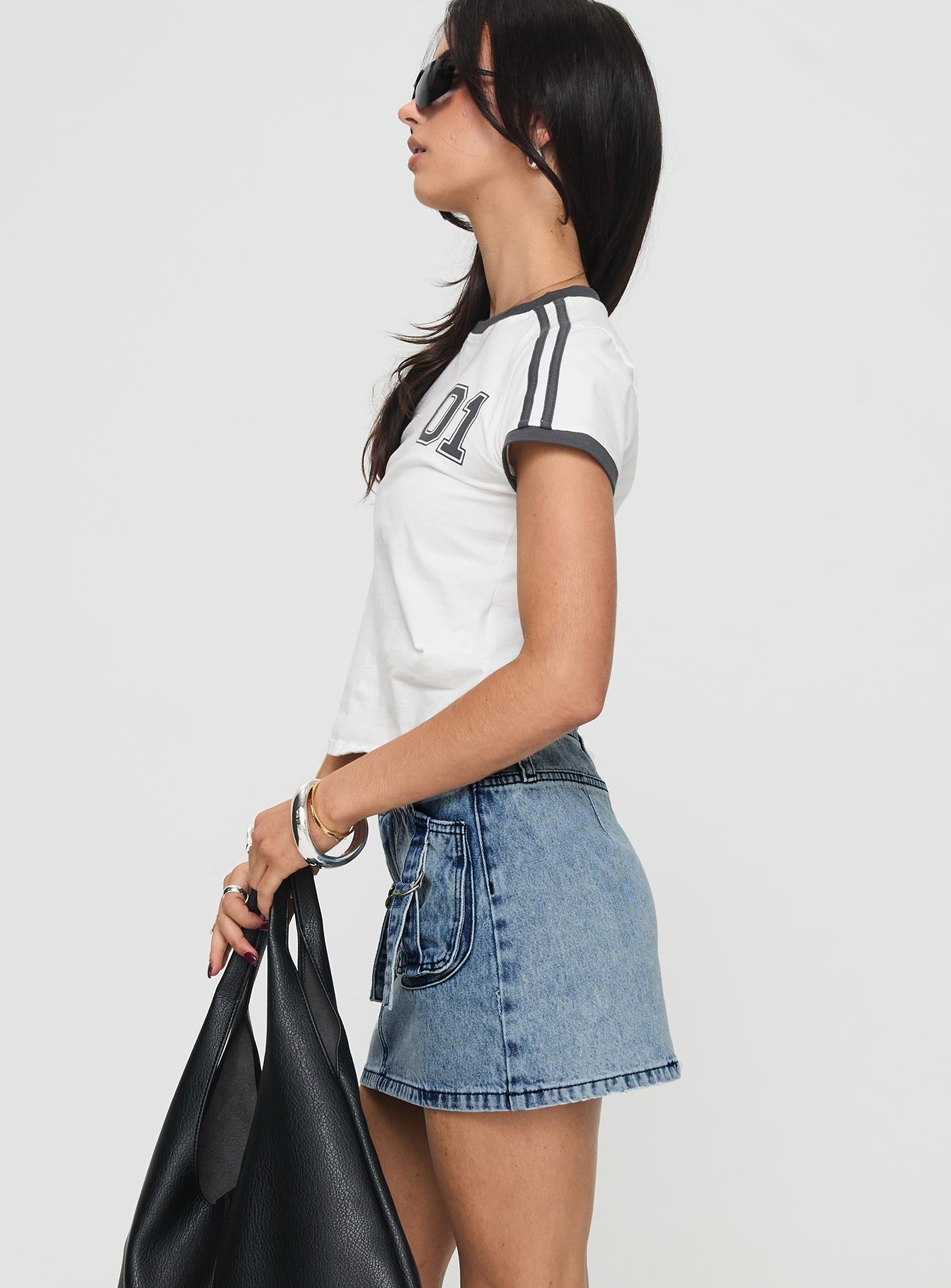   side view of model wearing Princess Polly Take Time Denim Mini Skirt Mid Wash Mini Skirts 