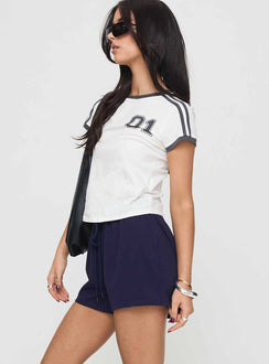 side view of model wearing Princess Polly Gavine Shorts Navy mid-rise 