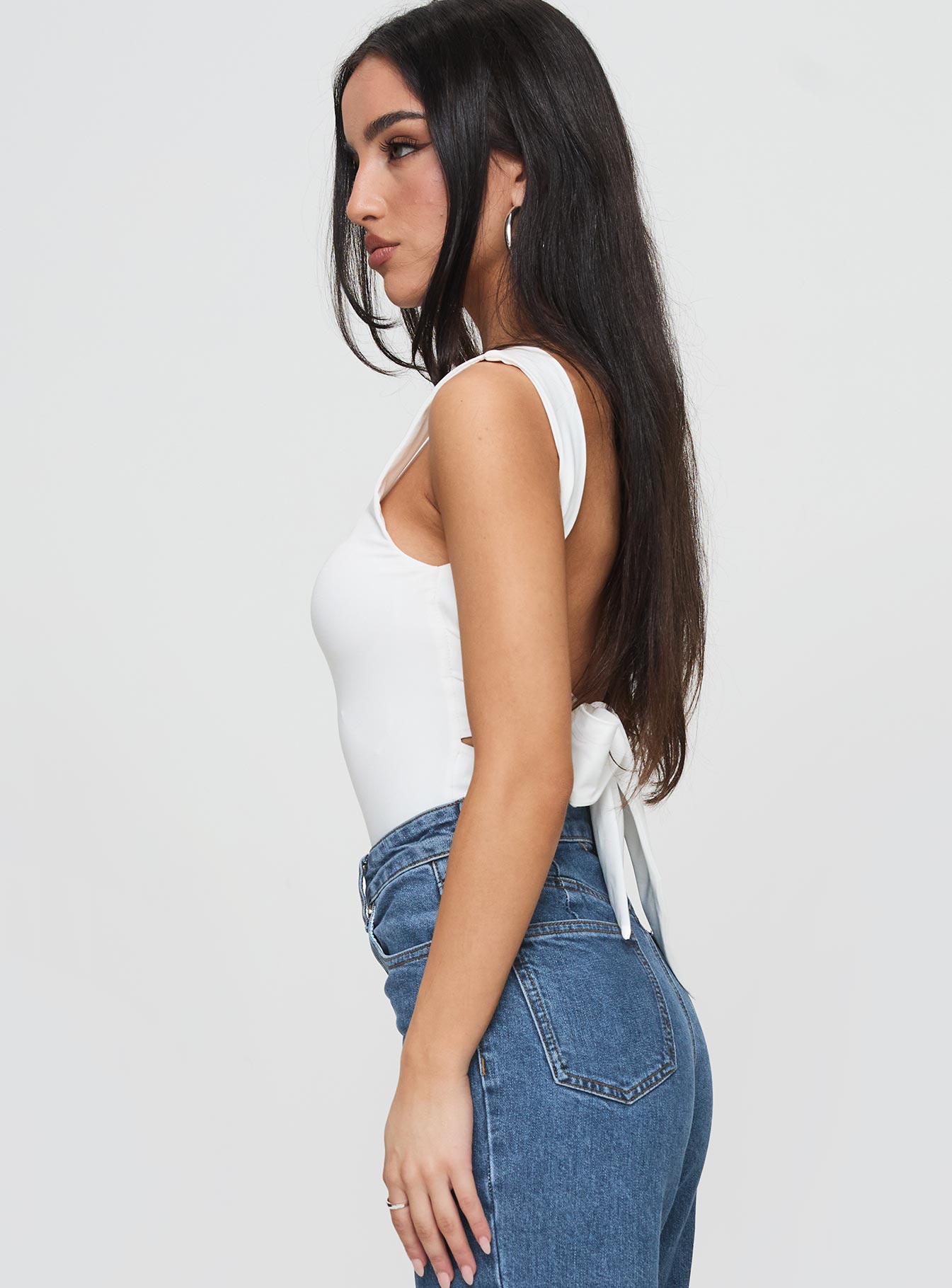 side view of model wearing Princess Polly Karissa Bodysuit White Sleeveless Square Neck 