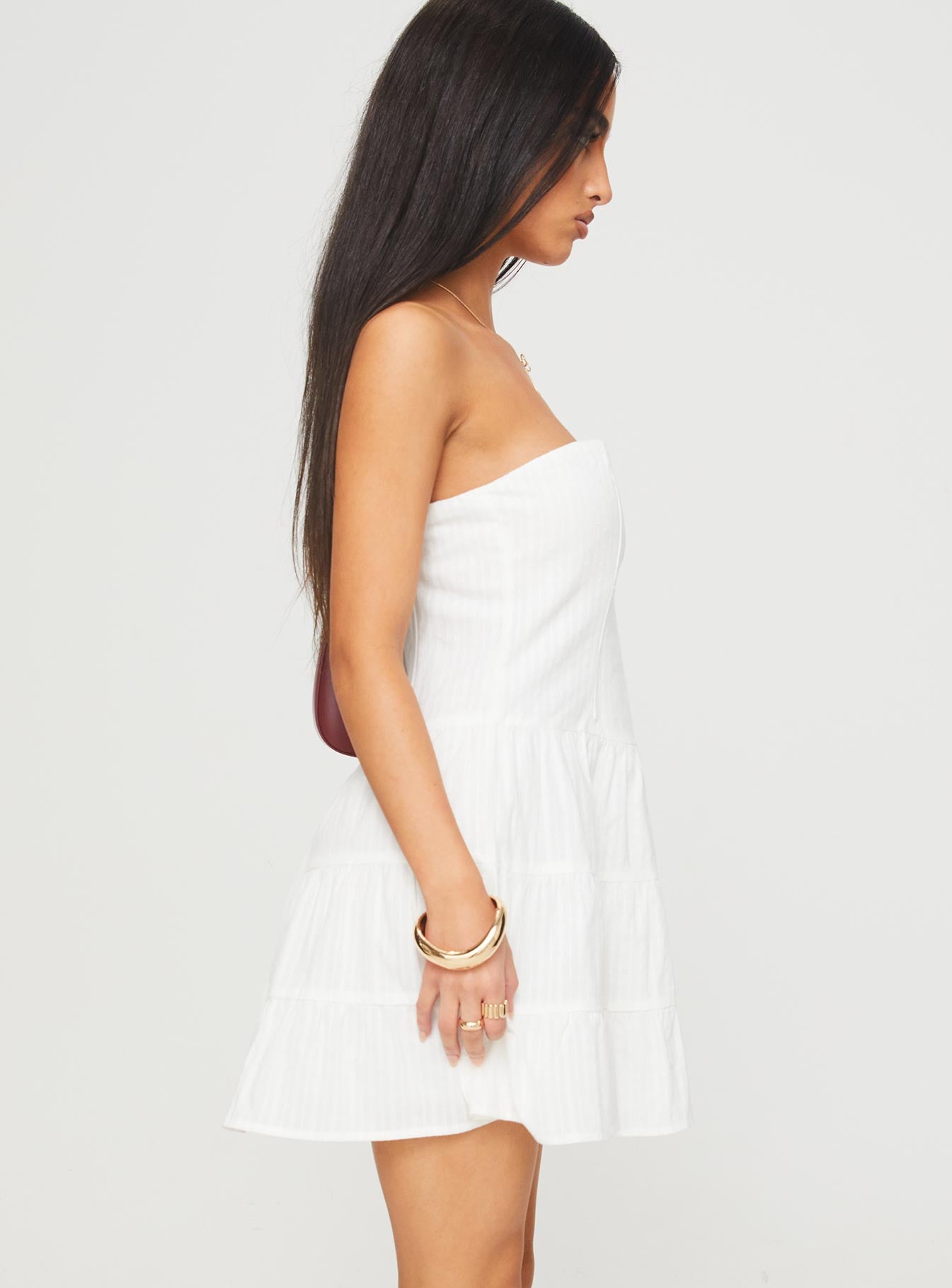 side view of model wearing Princess Polly Estria Strapless Mini Dress White Straight Neck 