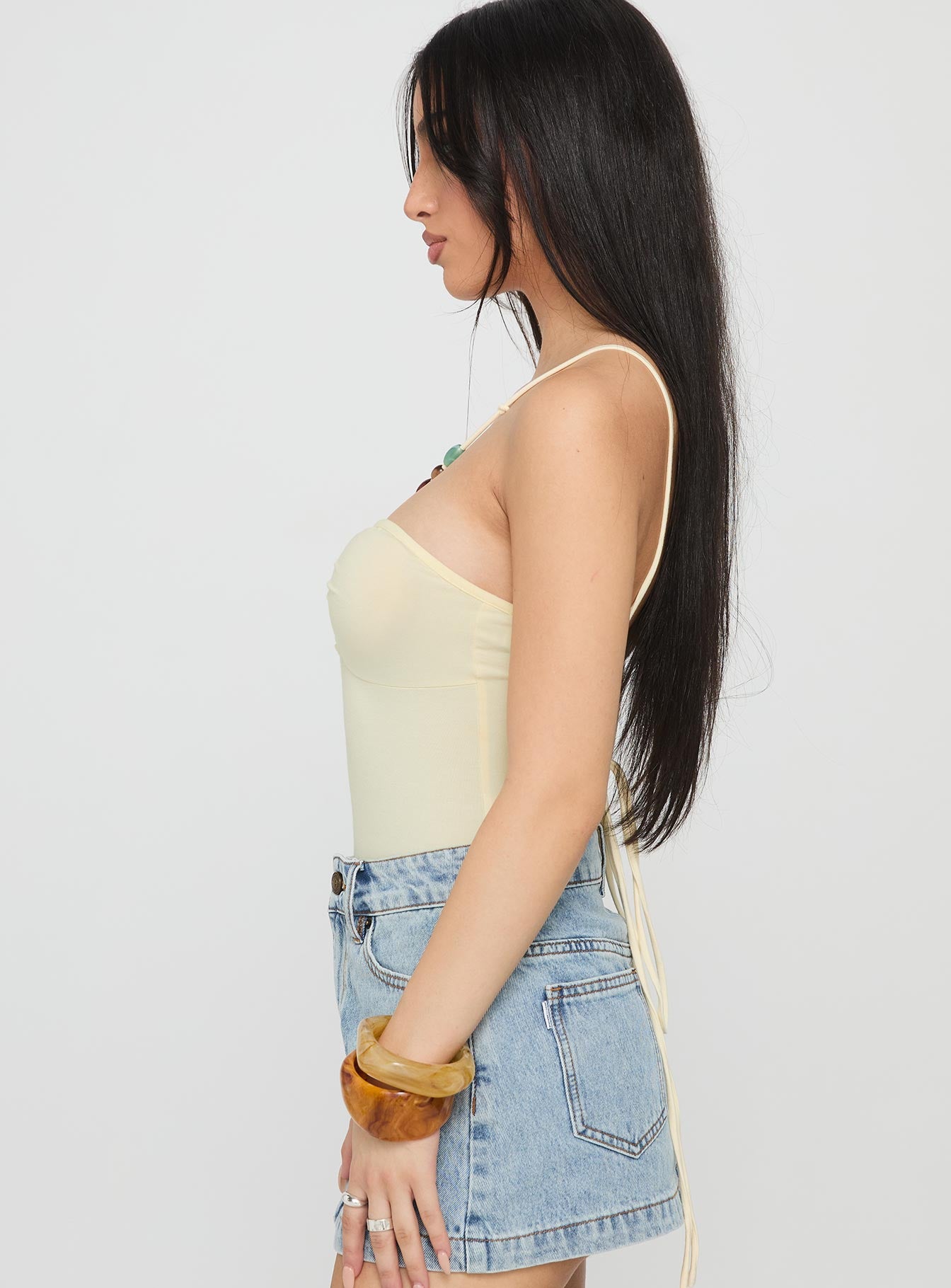 side view of model wearing Princess Polly Kianu Beaded Bodysuit Lemon Sleeveless 