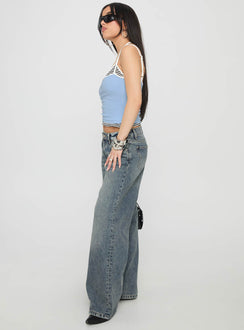 side view of model wearing Princess Polly Zaralyn Low Rise Wide Leg Jeans Mid Blue Wash Low Rise Jeans 