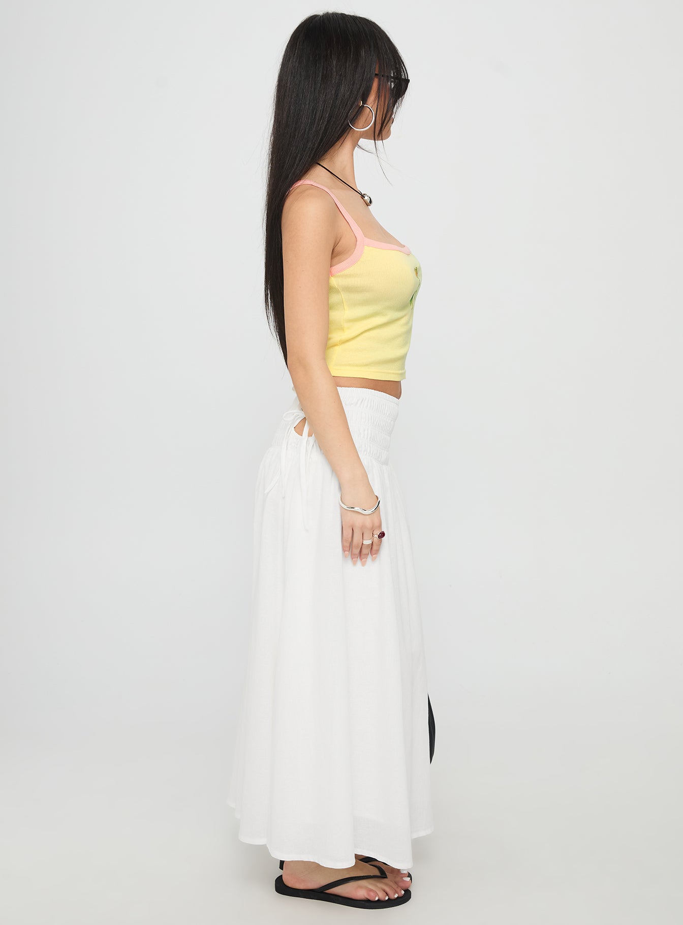   side view of model wearing Princess Polly Vence Ruched Maxi Skirt White Maxi 