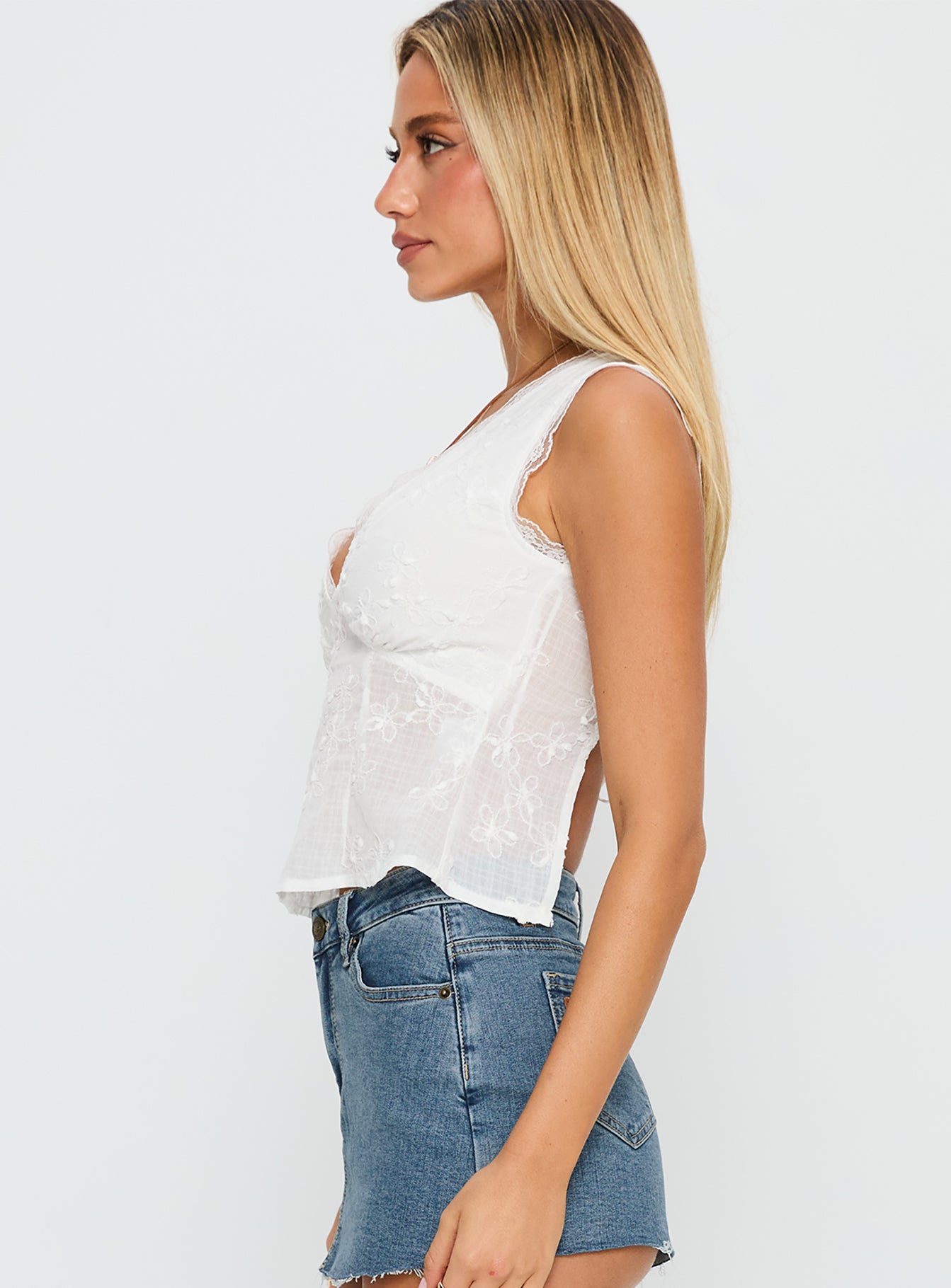 side view of model wearing Princess Polly Hagea Top White Sleeveless Plunger 