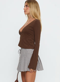  side view of model wearing Princess Polly Nikoleta Pleat Mini Skirt Brown / White Check Mini Skirts 