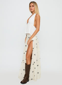   side view of model wearing Princess Polly Cinnamon Embroidered Maxi Skirt Cream / Navy Maxi 