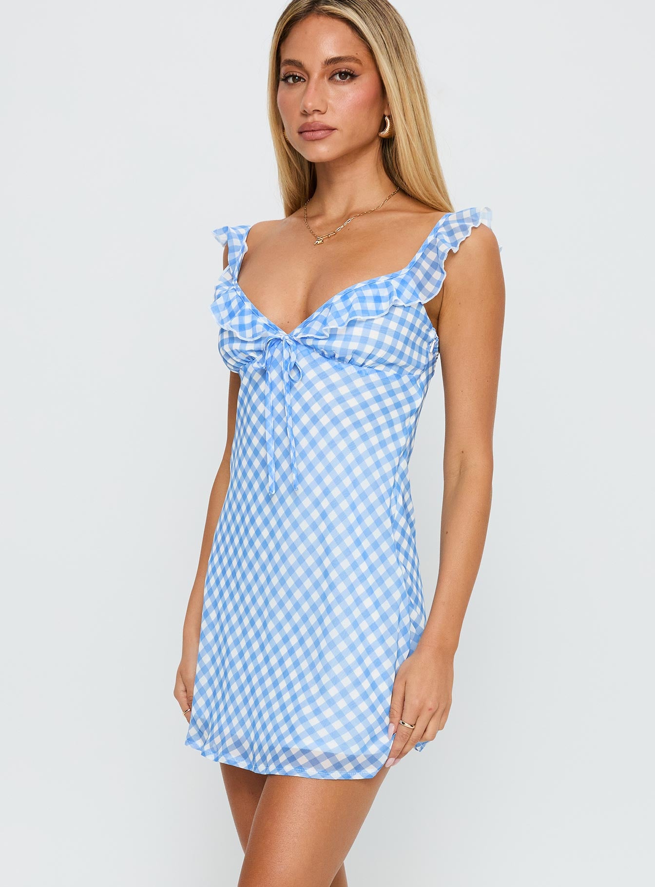 side view of model wearing Princess Polly Marseilla Mini Dress Blue Check Sweetheart Neckline 