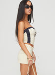   side view of model wearing Princess Polly Team Mini Skirt Cream Mini Skirts 