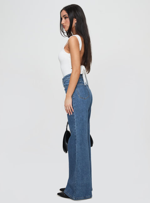 side view of model wearing Princess Polly Lucille High Rise Flare Leg Jeans Mid Wash High Waisted 