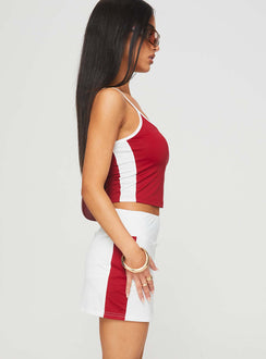 side view of model wearing Princess Polly Tex Skort White / Red 