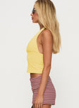 side view of model wearing Princess Polly Whimsy Halter Top Lemon Sleeveless Plunger 