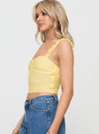 side view of model wearing Princess Polly Franca Top Yellow Sleeveless Sweetheart 