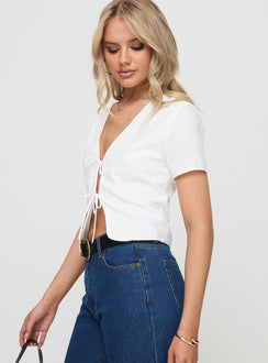 side view of model wearing Princess Polly Corriander Shirt White Short Sleeves V-Neck 