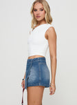 side view of model wearing Princess Polly Caruso Denim Wrap Skort Mid Blue Wash High Waisted Shorts 