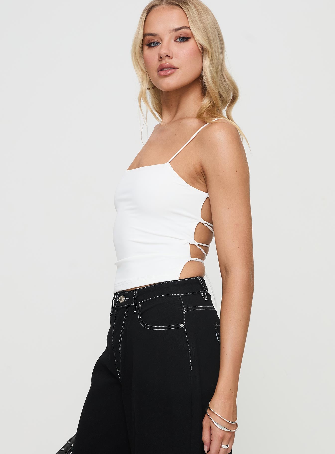 side view of model wearing Princess Polly Elissa Top White Sleeveless Square Neck 