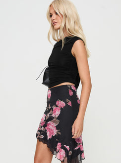   side view of model wearing Princess Polly Apricota Mini Skirt Black Floral Mini Skirts 