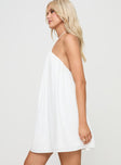 side view of model wearing Princess Polly Peaco Halter Mini Dress White Asymmetric Neckline 