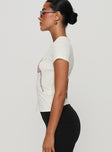 side view of model wearing Princess Polly By The Seaside Graphic Top Cream Short Sleeves Crew Neck 