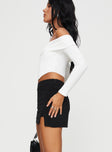 side view of model wearing Princess Polly Ravyn Skort Black Petite High Waisted Shorts 