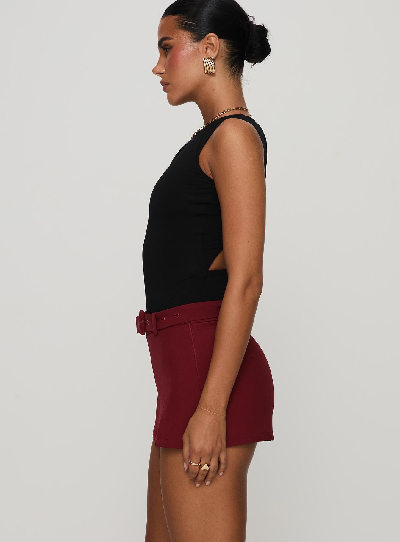 side view of model wearing Princess Polly Centre Stage Cut Out Bodysuit Black Sleeveless 