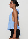 side view of model wearing Princess Polly Saddler Halter Top Blue Sleeveless Plunger 