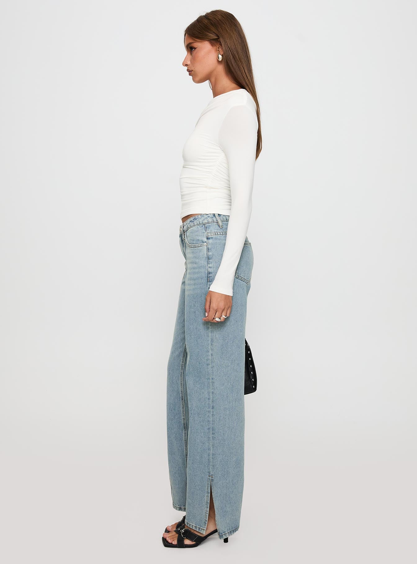 side view of model wearing Princess Polly White Mustang Side Split Jean Light Blue Mid Rise 