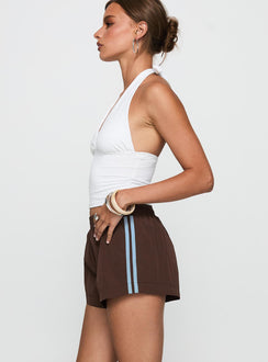 side view of model wearing Princess Polly Borderline Track Short Brown / Blue High Waisted Shorts 