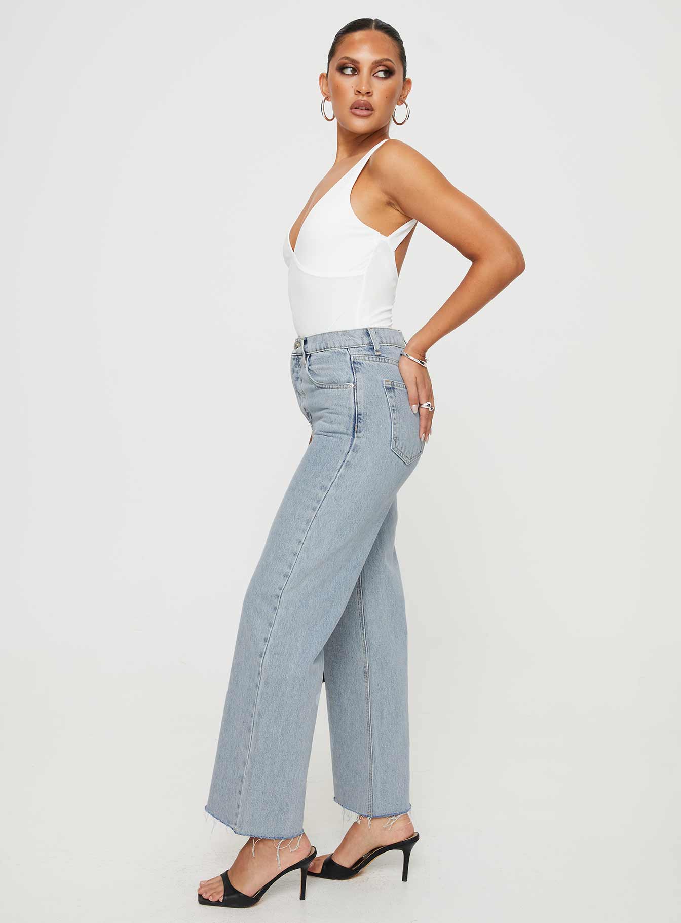 side view of model wearing Princess Polly Fawcett Jeans Light Wash Denim Tall High Waisted 
