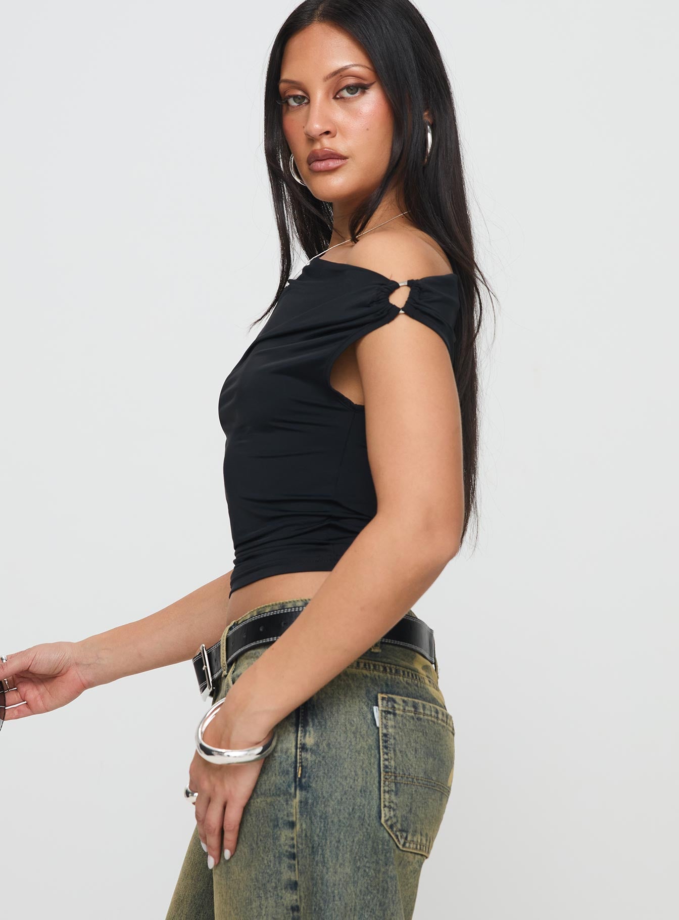 side view of model wearing Princess Polly Alckie Top Black Sleeveless Asymmetric Neckline 