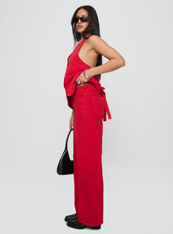 side view of model wearing Princess Polly Top Model Jeans Red Mid Rise 