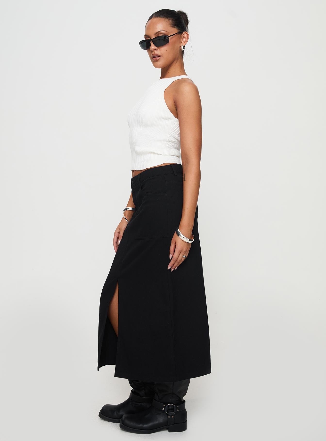   side view of model wearing Princess Polly Sumac Midi Skirt Black Midi Skirts 